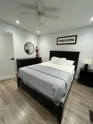 a bedroom with a large bed and a ceiling fan at Spectacular 3 BR 2 WR House - Close to Airport in Toronto