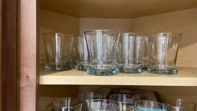 a bunch of glasses sitting on a shelf at Spectacular 3 BR 2 WR House - Close to Airport in Toronto