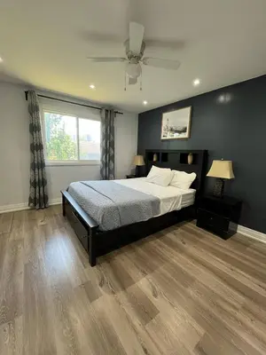 a bedroom with a bed and a ceiling fan at Spectacular 3 BR 2 WR House - Close to Airport in Toronto