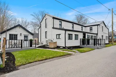 a large white house with a driveway at Luxe Lodges on Lake Erie in Port Dover