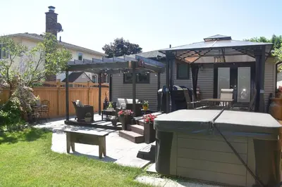 a backyard with a hot tub and a gazebo at Cozy Suite with HOT TUB & Highspeed Internet in Grimsby