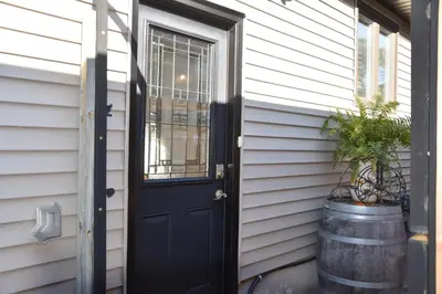 a black door on the side of a house at Cozy Suite with HOT TUB & Highspeed Internet in Grimsby