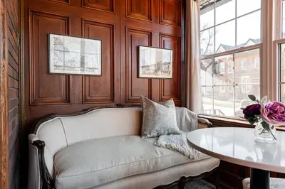 a living room with a couch and a table at Lake Suite with Sunroom by Henry House Stays in Stratford