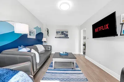 a living room with a couch and a tv at Harbour House in Hamilton