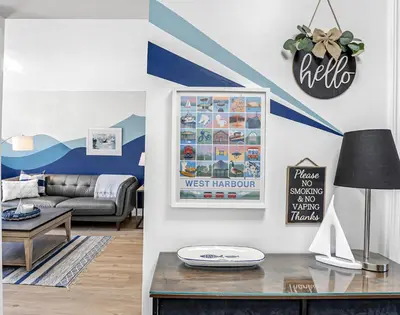 a living room with a blue and white striped wall at Harbour House in Hamilton