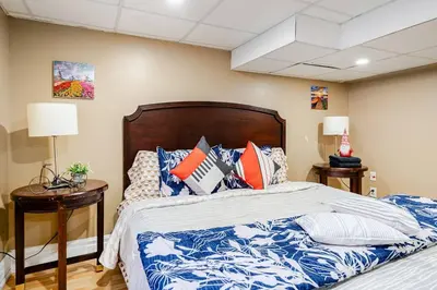 a bedroom with a bed with blue and white pillows at The Rustic Barn in Brampton