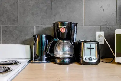 a coffee maker sitting on a counter next to a stove at The Rustic Barn in Brampton