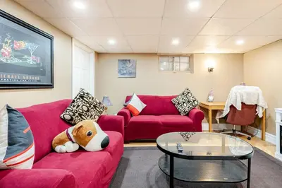 a living room with two red couches and a table at The Rustic Barn in Brampton