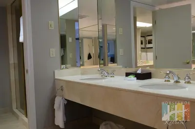 a bathroom with two sinks and two mirrors at Horseshoe Retreat in Edgar