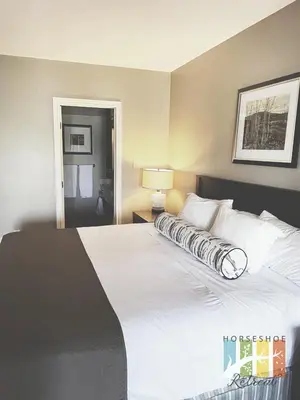 a large white bed in a hotel room at Horseshoe Retreat in Edgar