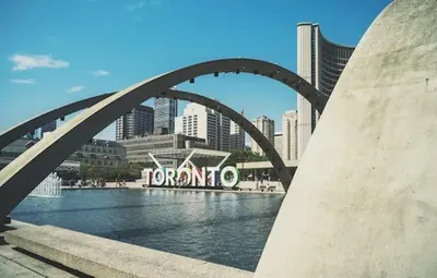 a bridge over a body of water in a city at Lovely 2 Bed Condo in Downtown Toronto in Toronto