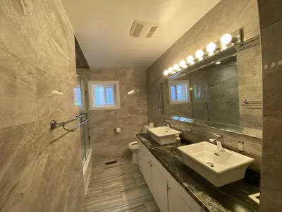 a bathroom with two sinks and a mirror at Yonge and Finch Subway !L Spacious & Bright Private Bedroom with Shared Amenties in Toronto