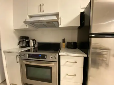 a kitchen with a stainless steel stove and refrigerator at Yorkmills and Bayview !C Cozy & Stylish Private Bdr with Shared Bathroom in Toronto