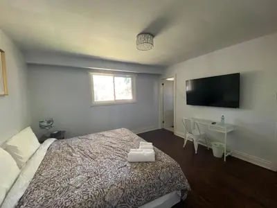 a bedroom with a bed and a desk and a television at Yonge and Finch Subway !O Cozy & Modern Private Bdr with Private Half Bathroom in Toronto