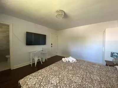 a bedroom with a bed with a tv on the wall at Yonge and Finch Subway !O Cozy & Modern Private Bdr with Private Half Bathroom in Toronto