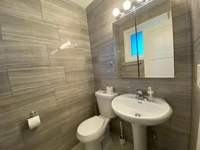 a bathroom with a toilet and a sink and a mirror at Yonge and Finch Subway !O Cozy & Modern Private Bdr with Private Half Bathroom in Toronto