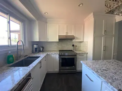 a kitchen with white cabinets and granite counter tops at Yonge and Finch Subway !P Cozy & Quiet Private Bdr with Private Bathroom in Toronto