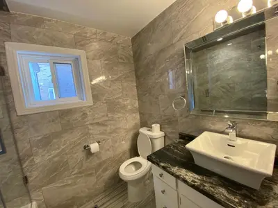 a bathroom with a sink and a toilet and a window at Yonge and Finch Subway !P Cozy & Quiet Private Bdr with Private Bathroom in Toronto