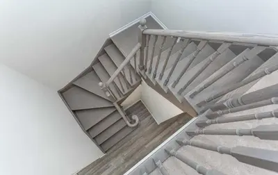 a staircase with a metal railing in a house at The Warm Welcome Suite in Thorold