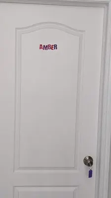 a white door with a sign on it at The Warm Welcome Suite in Thorold