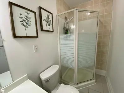 a bathroom with a toilet and a glass shower at Yorkmills and Bayview !A Spacious and Modern Private Bdr with Shared Bathroom in Toronto