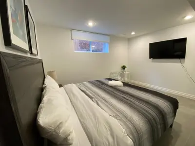 a bedroom with a bed and a flat screen tv at Yorkmills and Bayview !A Spacious and Modern Private Bdr with Shared Bathroom in Toronto