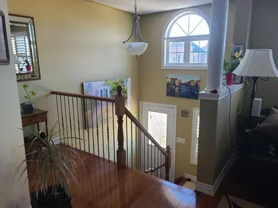 a living room with a staircase and a window at Top Floor of House in S Vaughan All to Yourself in Vaughan