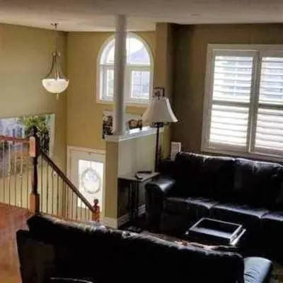 a living room with a black couch and a window at Top Floor of House in S Vaughan All to Yourself in Vaughan