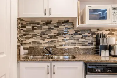 a kitchen with a sink and a microwave at Slope-side Studio Bliss Ski-in Ski-out, Renovated At Blue, Hot Tub, Fast Wi-Fi in Blue Mountains