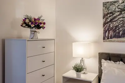 a bedroom with a dresser with a vase of flowers on it at Slope-side Studio Bliss Ski-in Ski-out, Renovated At Blue, Hot Tub, Fast Wi-Fi in Blue Mountains