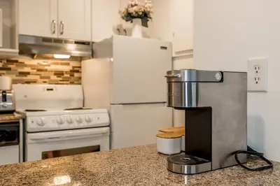 a kitchen with a coffee maker on a counter at Slope-side Studio Bliss Ski-in Ski-out, Renovated At Blue, Hot Tub, Fast Wi-Fi in Blue Mountains