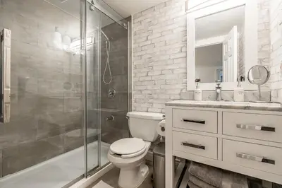 a bathroom with a shower and a toilet and a sink at Slope-side Studio Bliss Ski-in Ski-out, Renovated At Blue, Hot Tub, Fast Wi-Fi in Blue Mountains