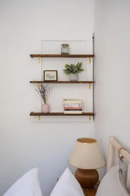 a room with shelves on the wall and a lamp at The Darcie House - cozy, pet-friendly home in PEC in Picton