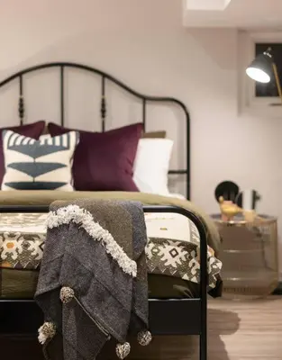 a bed with purple and white pillows on it at Professionally Designed 1-Bedroom in Prime Toronto in Toronto