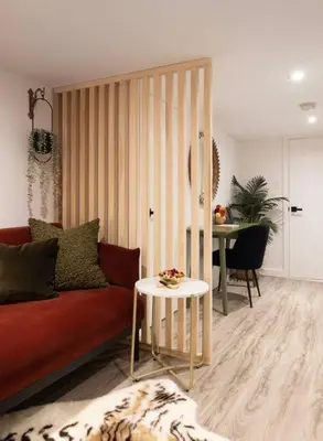 a living room with a red couch and a table at Professionally Designed 1-Bedroom in Prime Toronto in Toronto