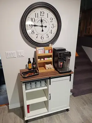 a large clock hanging on a wall above a counter at Fireside - Waterfront Resort Style Executive Cottage in Kawartha Lakes