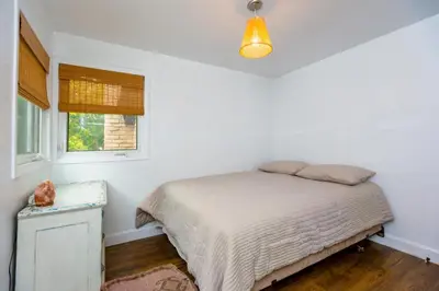 a white bedroom with a bed and a window at Cosy 3-Bedroom Home in Quiet Cul-de-Sac. in Pickering