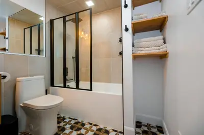 a bathroom with a white toilet and a shower at Cosy 3-Bedroom Home in Quiet Cul-de-Sac. in Pickering