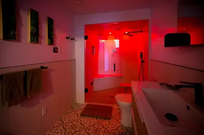 a red bathroom with a toilet and a sink at Cosy 3-Bedroom Home in Quiet Cul-de-Sac. in Pickering