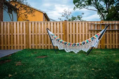 a hammock in a yard next to a fence at Cosy 3-Bedroom Home in Quiet Cul-de-Sac. in Pickering