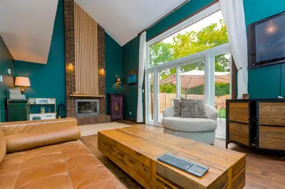 a living room with a couch and a tv at Cosy 3-Bedroom Home in Quiet Cul-de-Sac. in Pickering