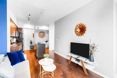 a living room with a couch and a flat screen tv at AOC Suites - High-Rise Condo - City View in Toronto