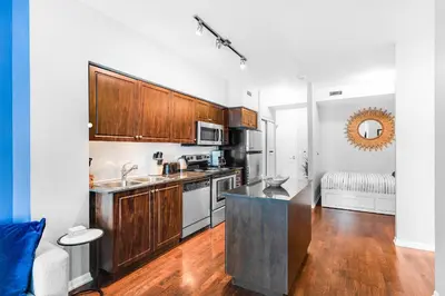 a kitchen with wooden cabinets and a counter top at AOC Suites - High-Rise Condo - City View in Toronto