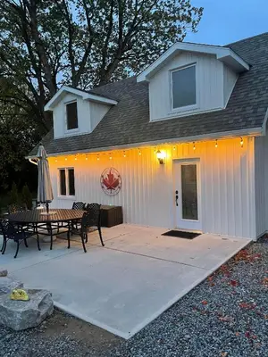 a white building with a patio and a table at Villa in the Vines in Niagara on the Lake