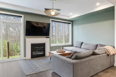 a living room with a couch and a fireplace at Jewel of Blue Mountain - Walk to Ski and Village - EV plug in Blue Mountains