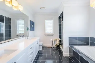 a bathroom with a tub and a sink and a toilet at Beautiful Family Villa, Pond Facing with Huge Backyard in Brampton