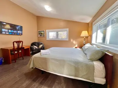 a bedroom with a bed and a desk and a chair at Newly Renovated Home in Central Aurora in Aurora