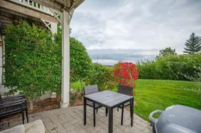a table and chairs sitting on a patio at Blue Mountain Retreat at Rivergrass in Blue Mountains