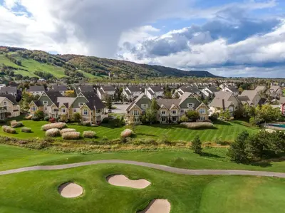 a view of a golf course with houses at Blue Mountain Retreat at Rivergrass in Blue Mountains