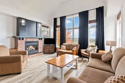 a living room with furniture and a fireplace at Spectacular Rivergrass Chalet Steps to Blue Mtn in Blue Mountains